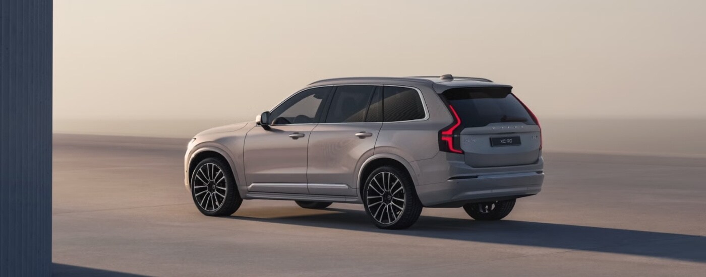 A tan 2025 Volvo XC90 is shown from the side.