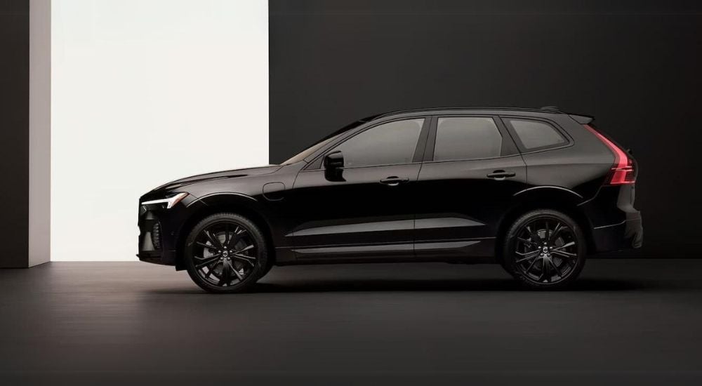 A black 2024 Volvo XC60 Black Edition is shown from the side after visiting a Volvo dealership near Pittsfield.