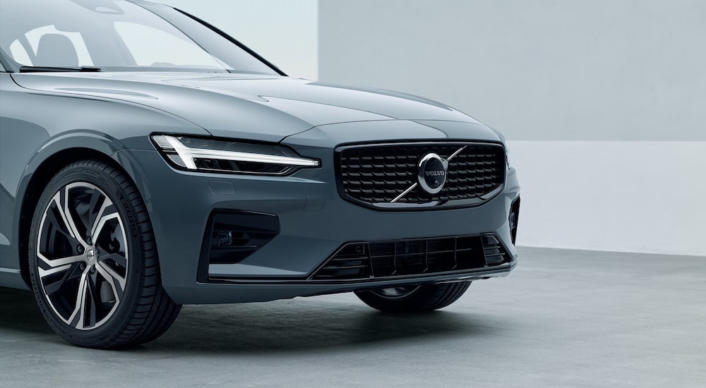 A close-up of the front end of a slate blue 2024 Volvo S60.