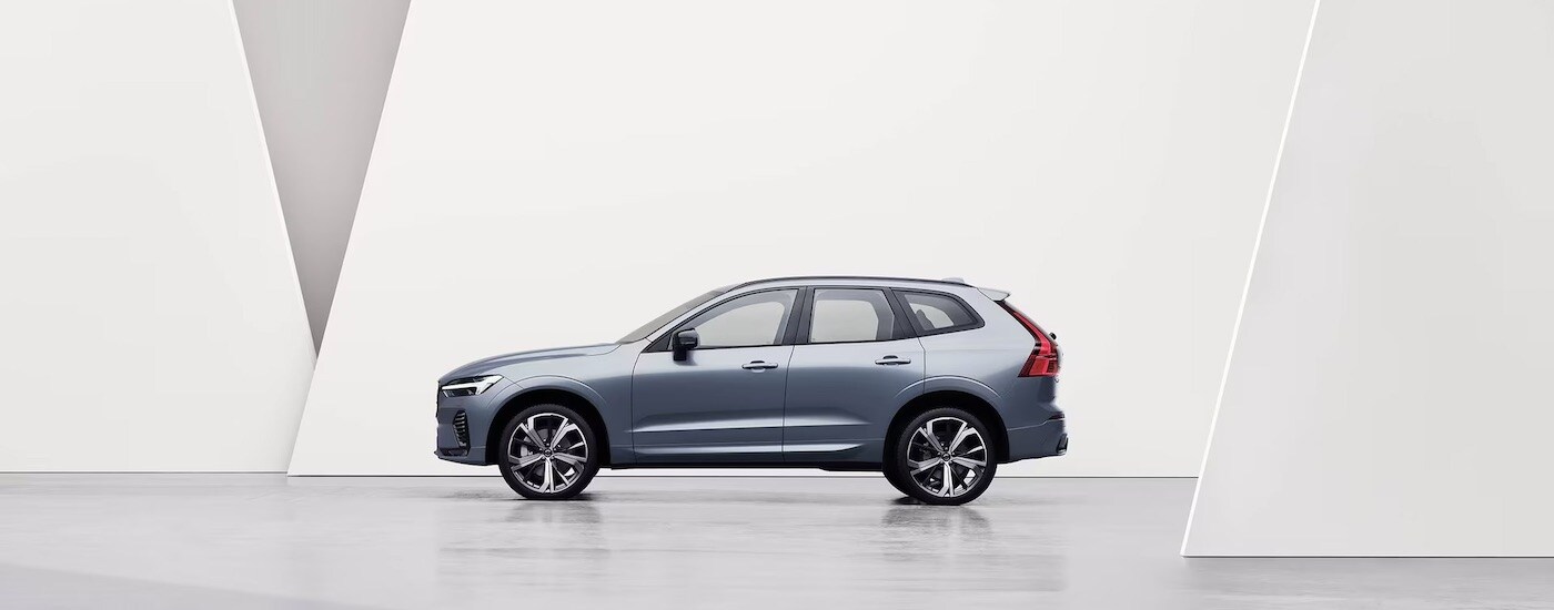 A grey 2024 Volvo XC60 is shown from the side.