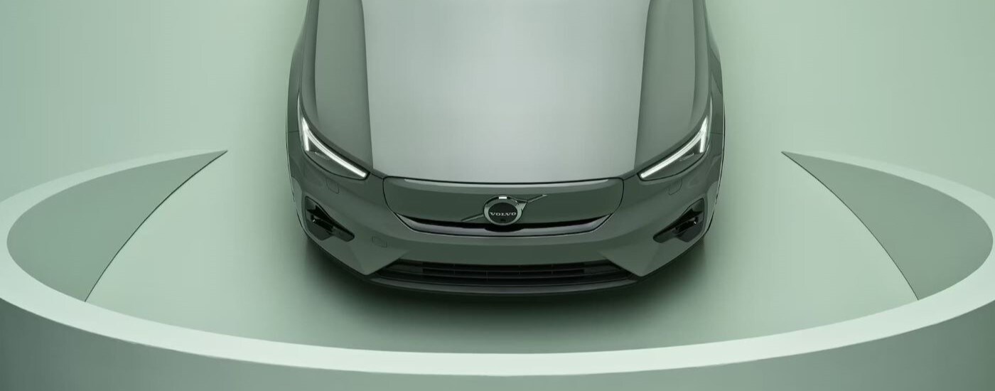 A close-up on the hood of a green 2024 Volvo XC40 parked at a Volvo dealer near Bennington.