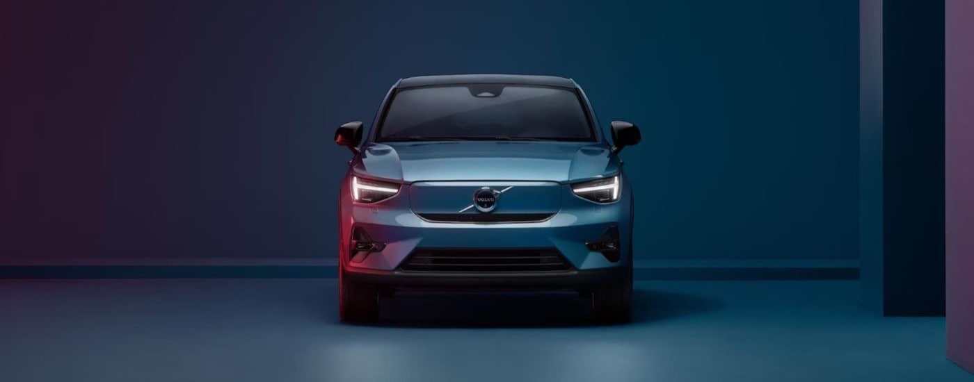 A blue 2024 Volvo C40 Recharge is shown from the front after visiting a Volvo dealership.