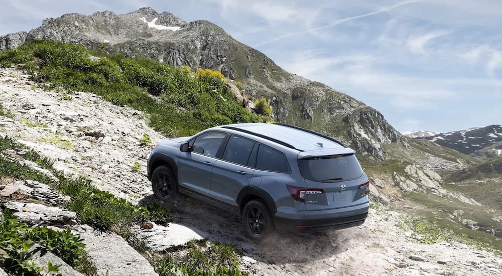 A grey 2024 Honda Pilot Trailsport is shown from the rear at an angle.