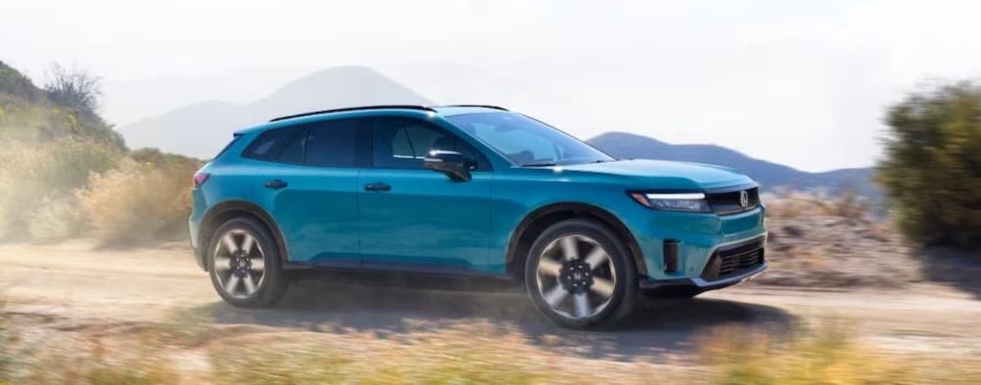 A teal 2024 Honda Prologue is shown from the side after leaving a dealer that has Honda EVs for sale.