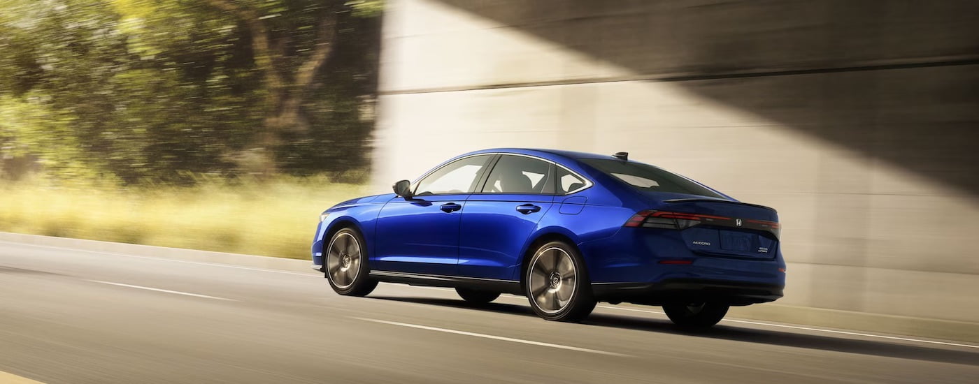 A blue 2024 Honda Accord is shown from the rear at an angle.