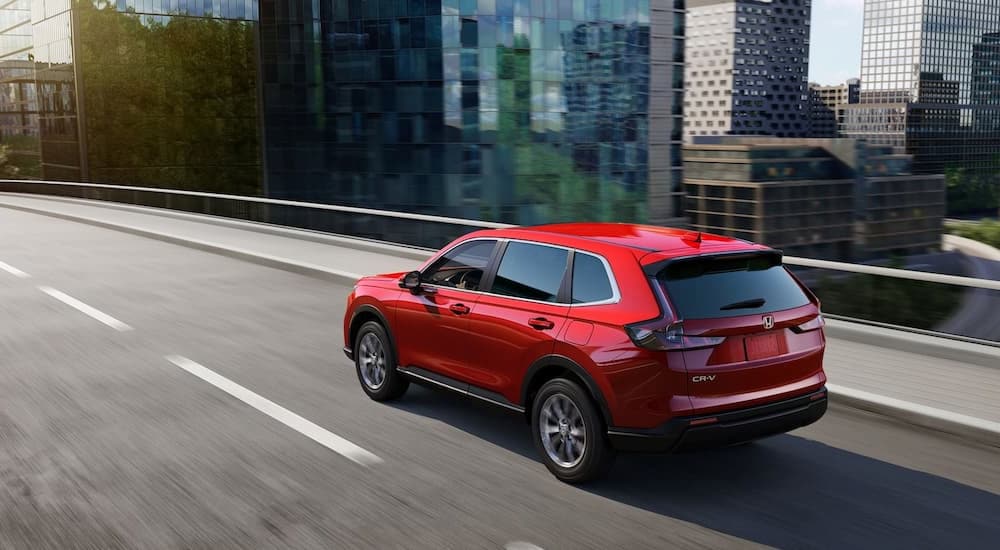 Overhead view of a red 2025 Honda CR-V EX driving through the city.