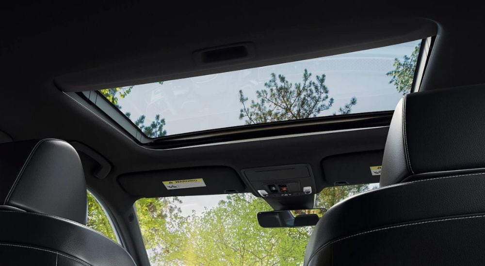 A close-up shows the moonroof in a 2025 Honda Civic Hybrid Sport Touring.