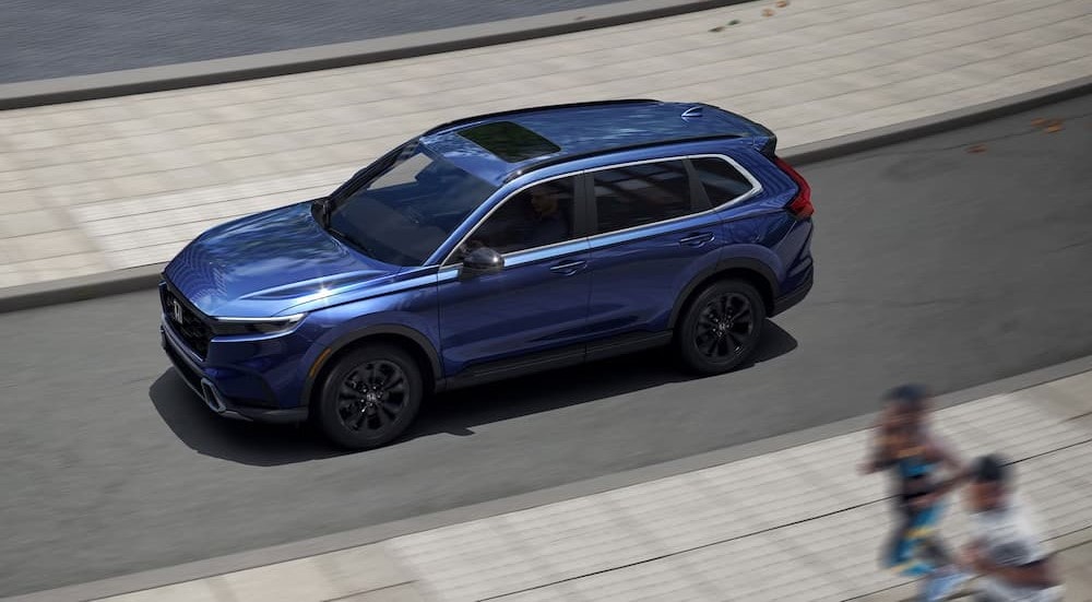 An aerial view of a 2025 Honda CR-V Sport Touring Hybrid driving.