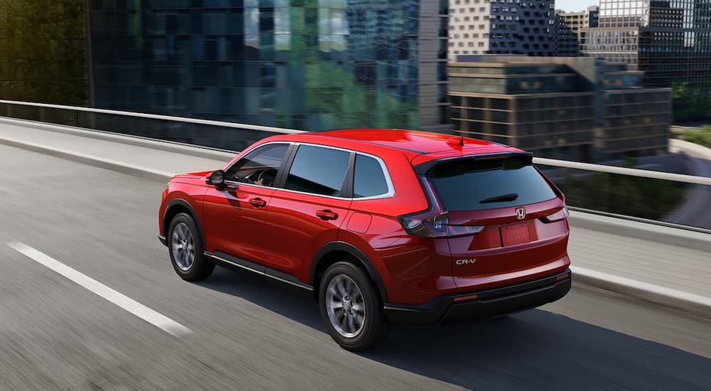 A red 2025 Honda CR-V for sale is shown from the rear at an angle.