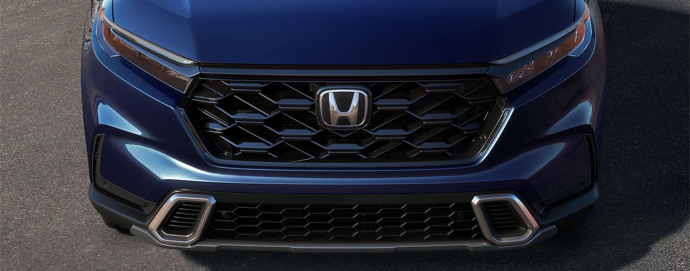A close up of the grille on a blue 2024 Honda CR-V for sale.