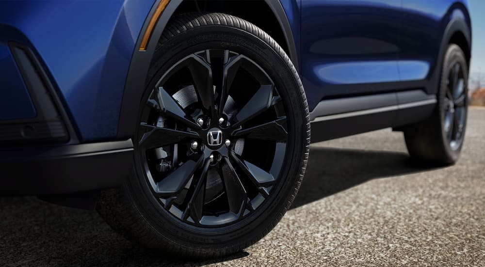 Close-up of a wheel on a blue 2025 Honda CR-V Sport Touring Hybrid