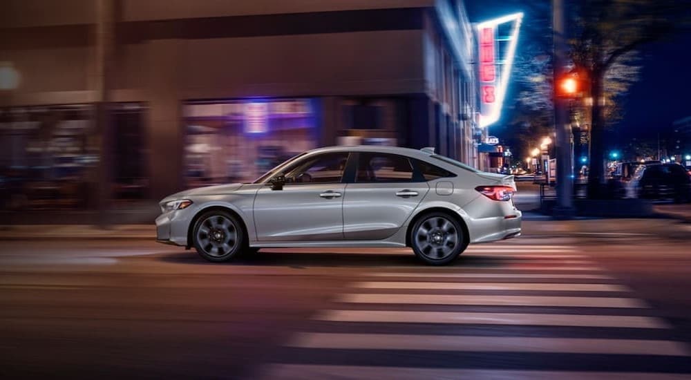 Honda%20Civic%20for%20sale%20-%202025%20Honda%20Civic%20-%20Silver.jpg A silver 2025 Honda Civic for sale is shown driving on a city street.