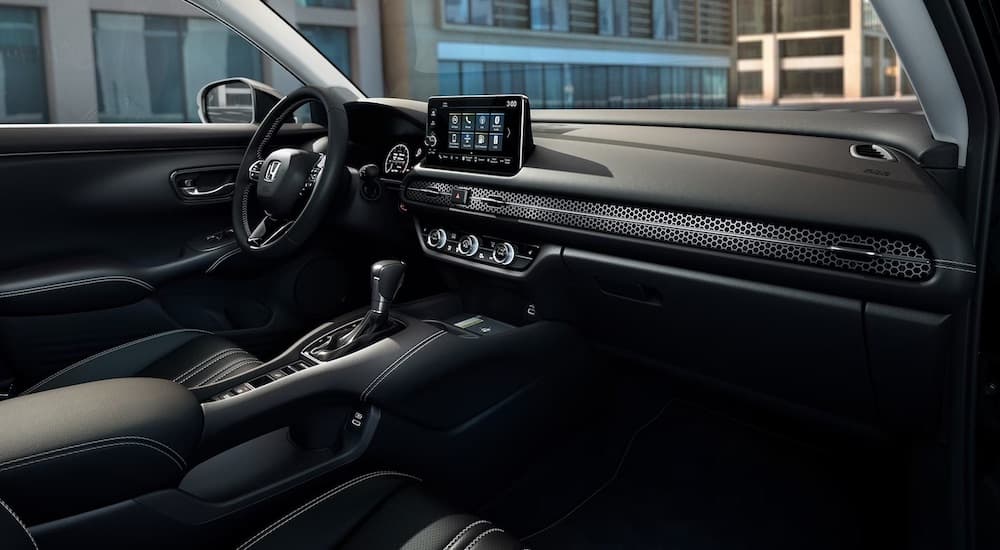 The black interior of a 2024 Honda HR-V is shown from the passenger side.