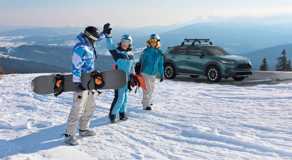 Snowboarders are shown near a 2025 Honda HR-V.
