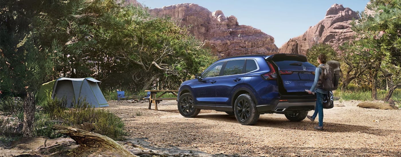 A blue 2025 Honda CR-V Hybrid from behind.