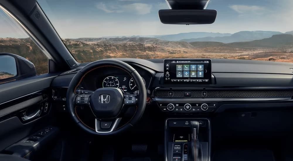 The black interior and dash are shown in a 2025 Honda CR-V Hybrid for sale.