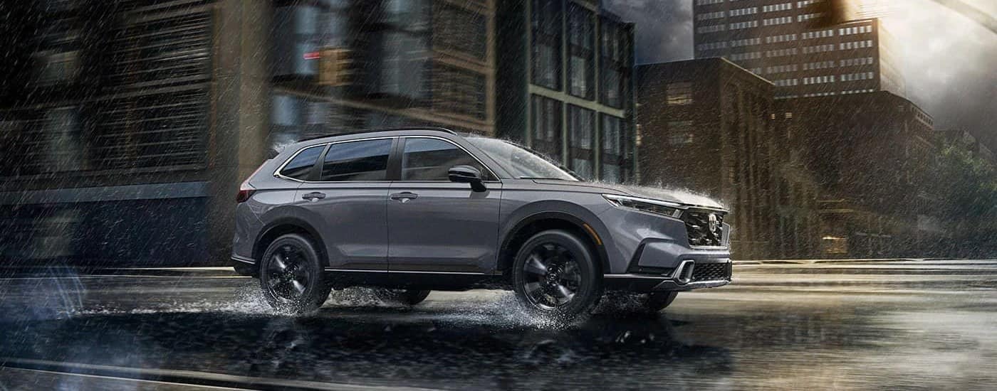 A grey 2025 Honda CR-V Hybrid for sale in Cheshire on a rainy street.