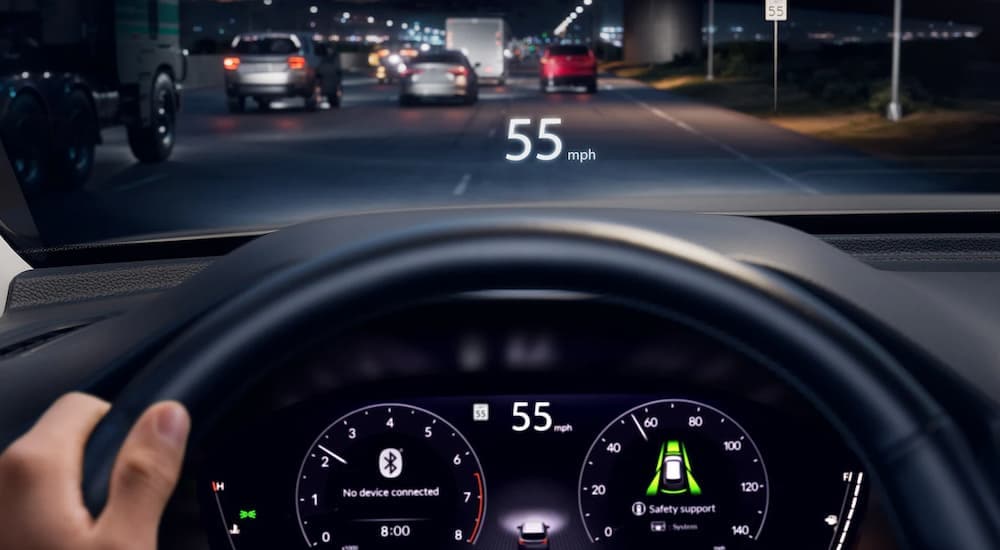 A close up view of a 2025 Honda Pilot Elite's heads up display and steering wheel.