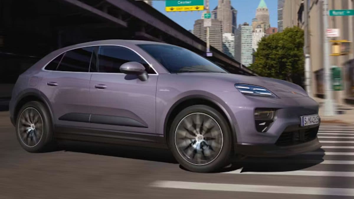 Porsche Macan Electric driving around a corner