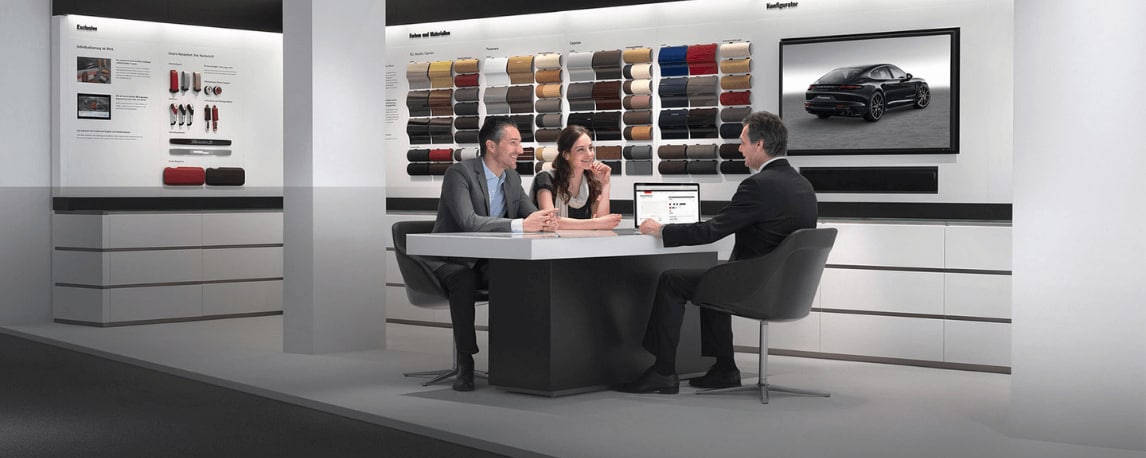 Couple personalizing their dream Porsche at a Porsche showroom