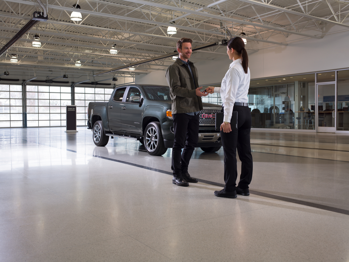 GMC dealer helping a client