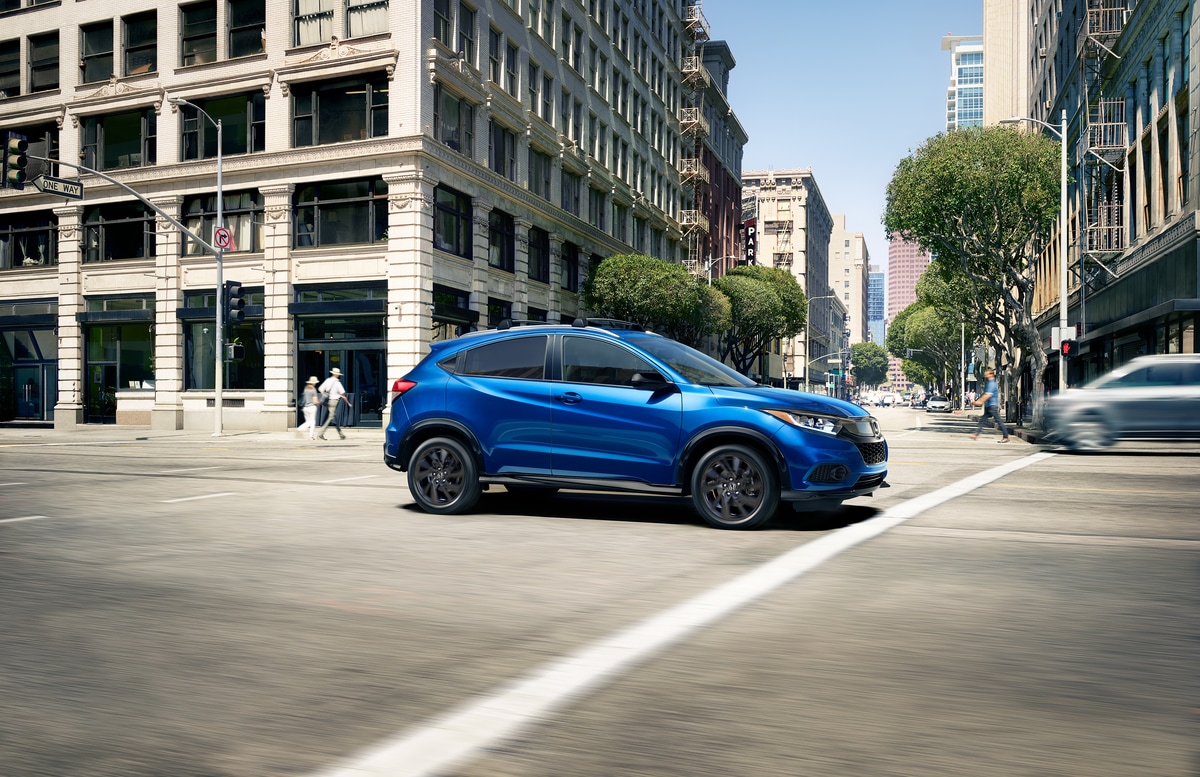 blue Honda HR-V SUV, sport, driving through an intersection in the city