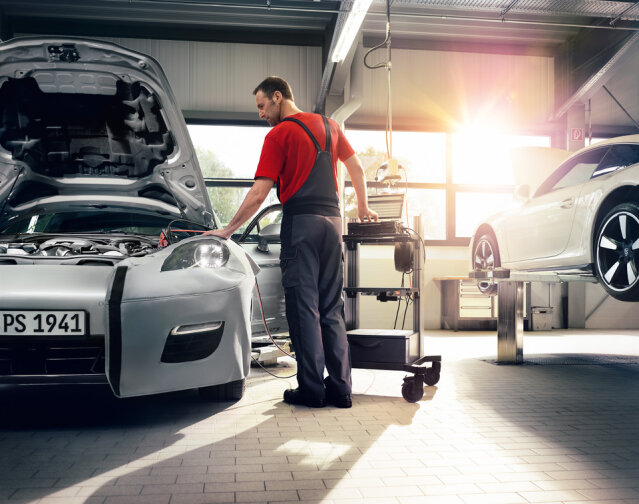 Exotic car service technician performing tests