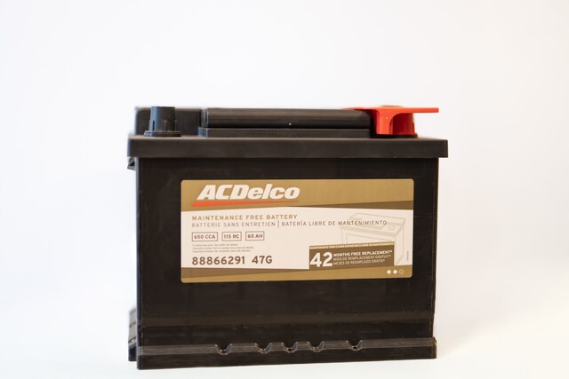Technician testing a vehicle battery