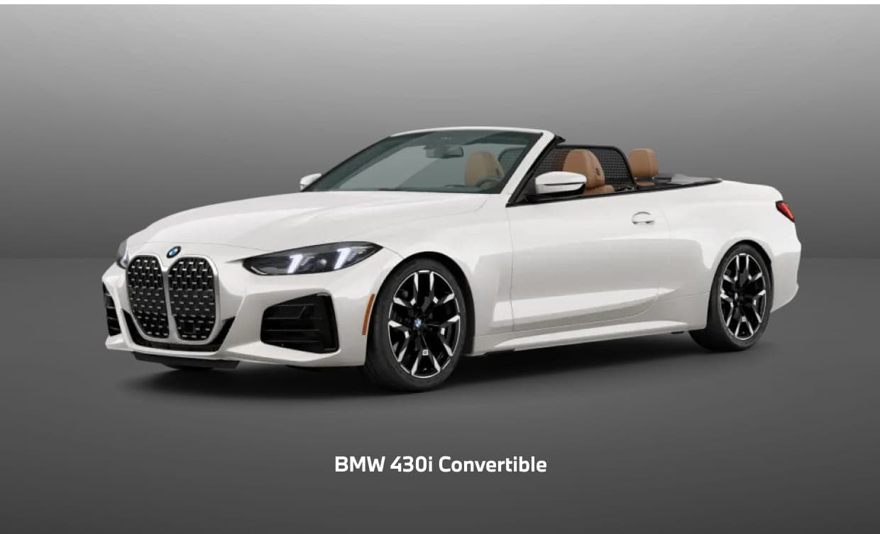 White BMW 430i Convertible with the top down, shown from a front three-quarter angle.