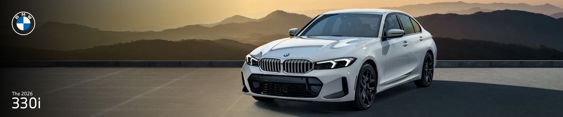 2026 BMW 330i in Alpine White, front three-quarter view on a terrace with mountains at sunset.