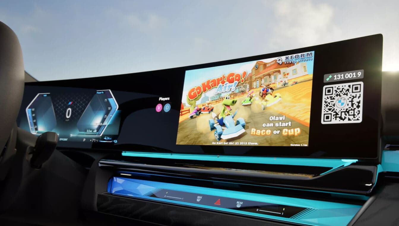 Interior close-up of the BMW 550e infotainment system displaying a video game.