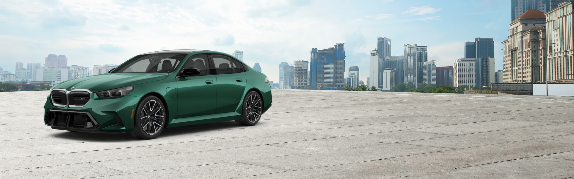 A 2027 BMW M5 parked in a sunny urban parking lot with a city skyline in the background.