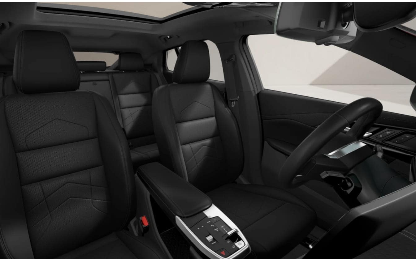 A view of the BMW X2 interior featuring black front and rear seats, a multifunction steering wheel, and a modern center console.