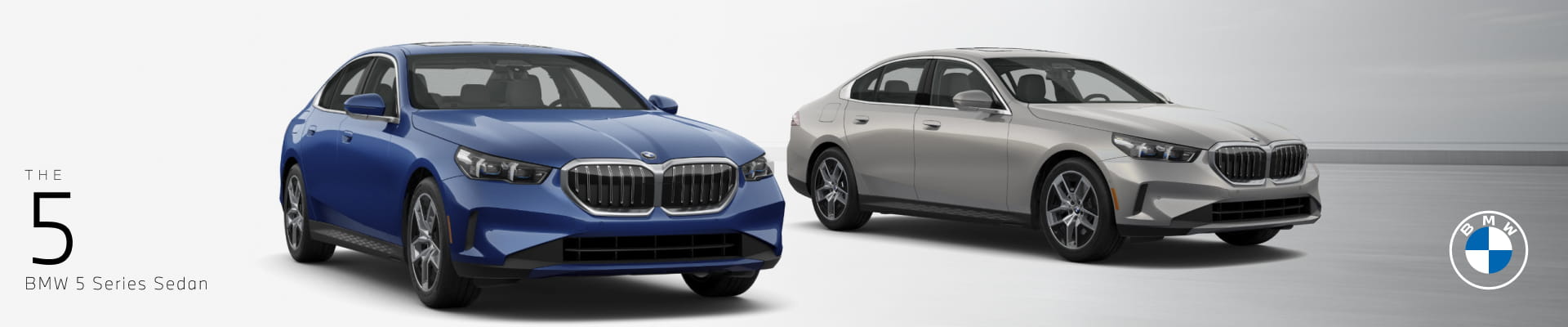 Blue and silver BMW 5 Series sedans displayed side by side against a clean studio background.