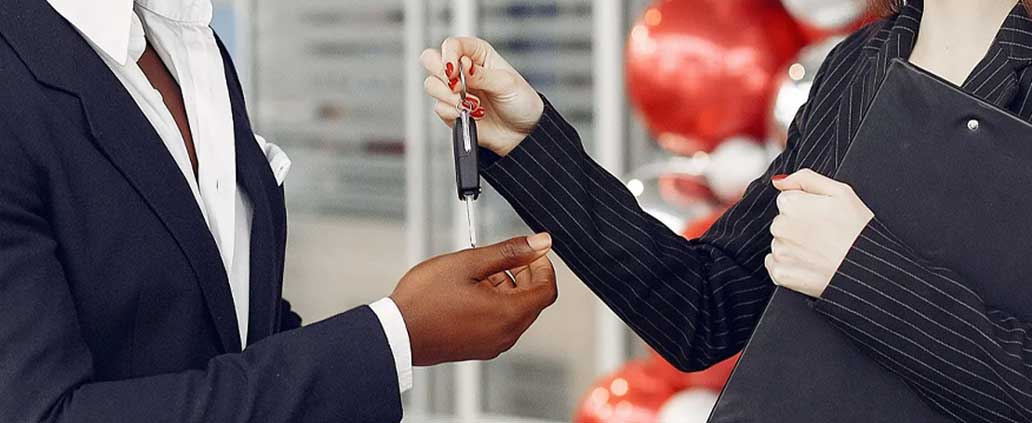 Auto Professional Handing Car Keys to Client