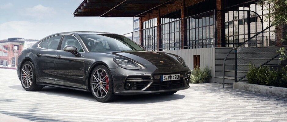 Porsche Panamera Trim Packages A black Porsche Panamera parked outside of a building