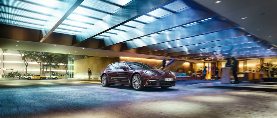 Porsche Panamera Models A Porsche Panamera driving up to a valet