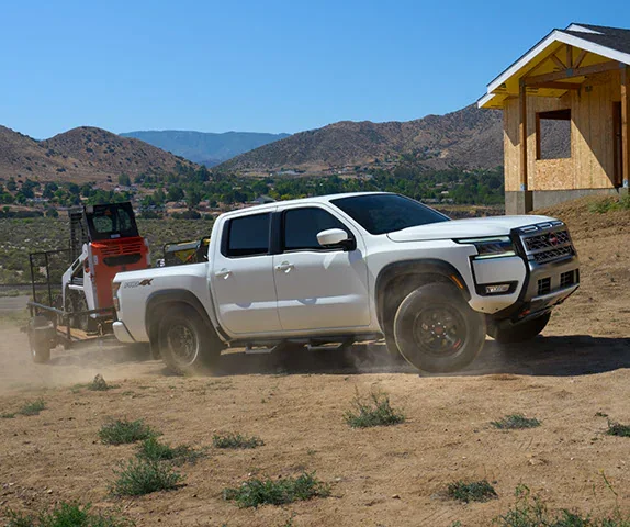 Nissan Frontier Crew Cab PRO-4X towing a trailer, a midsize truck for Kent Valley trades