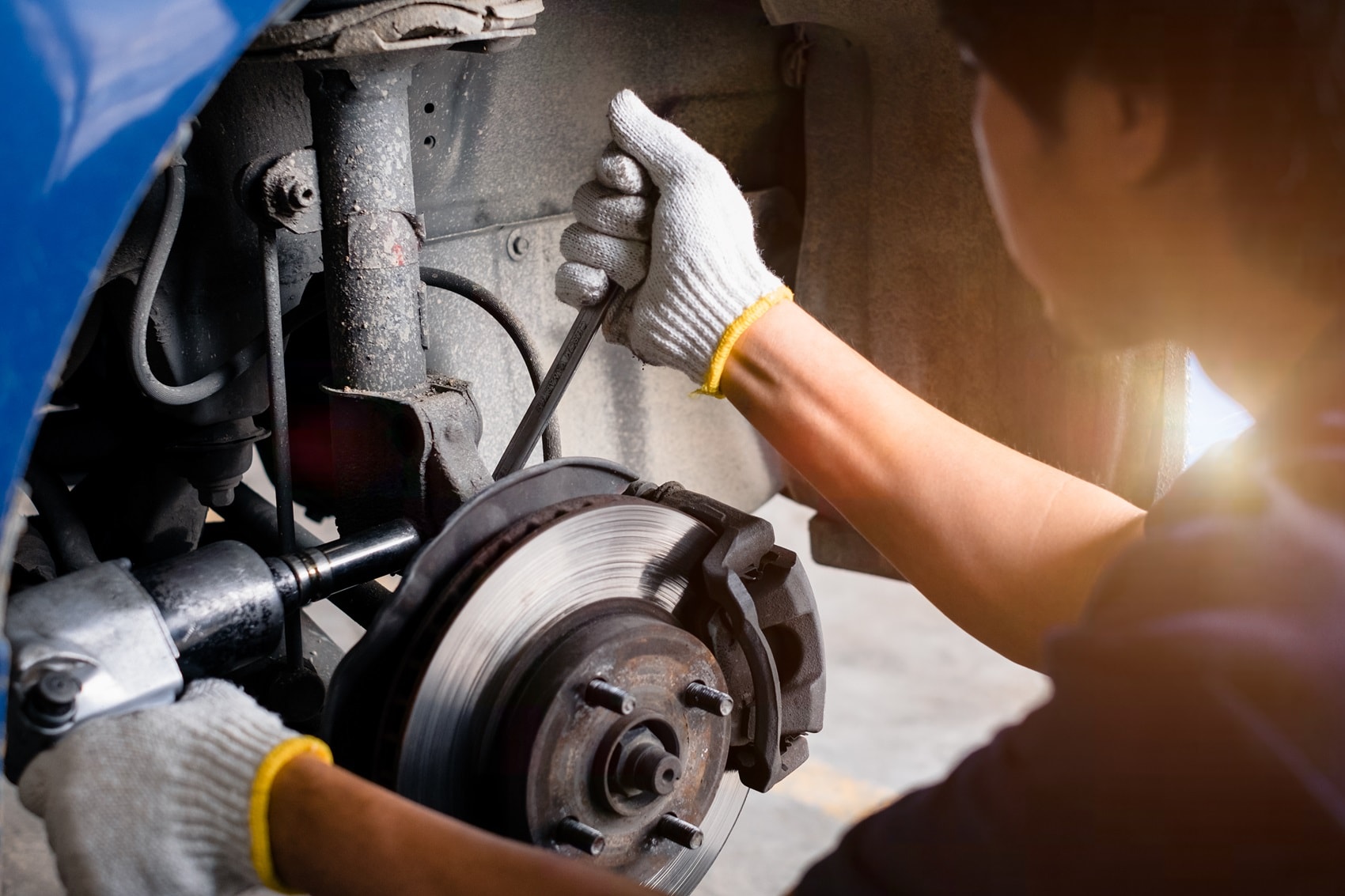 Chevy Service Technician Fixing a Car's Brakes