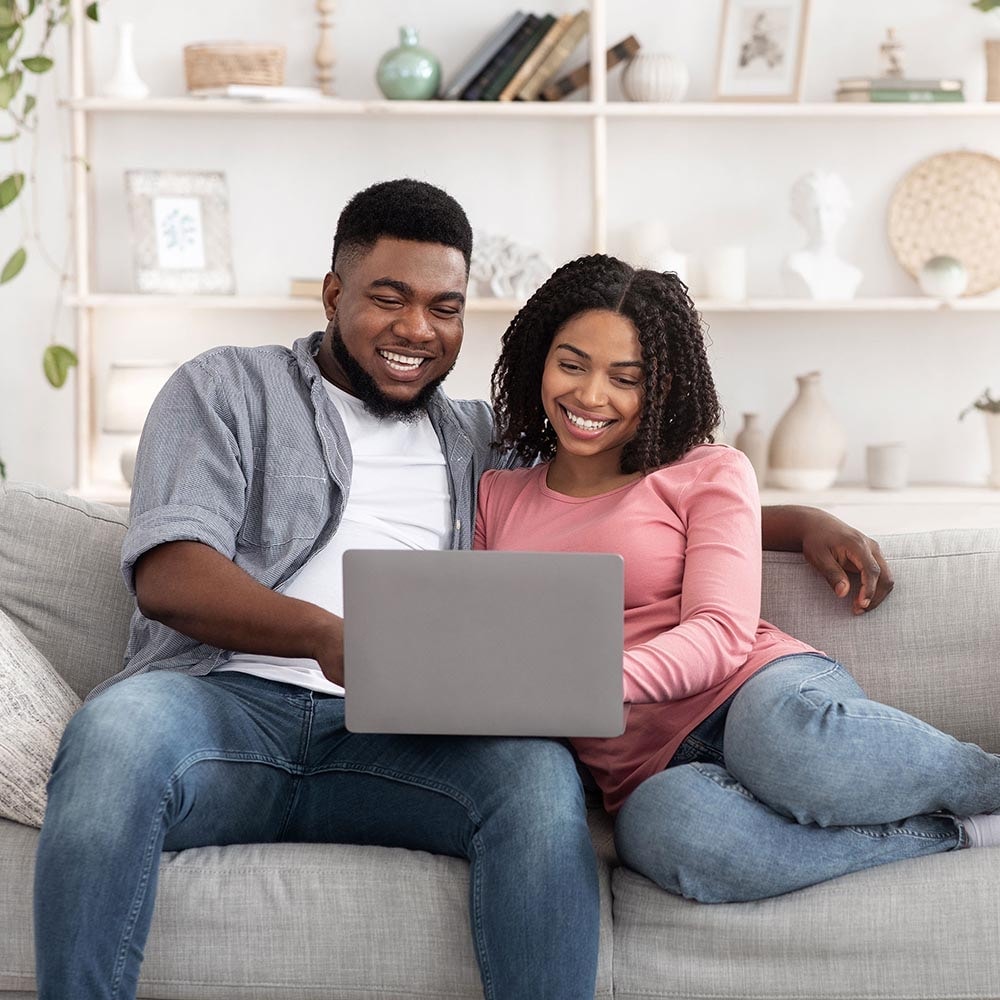 Couple on couch with computer