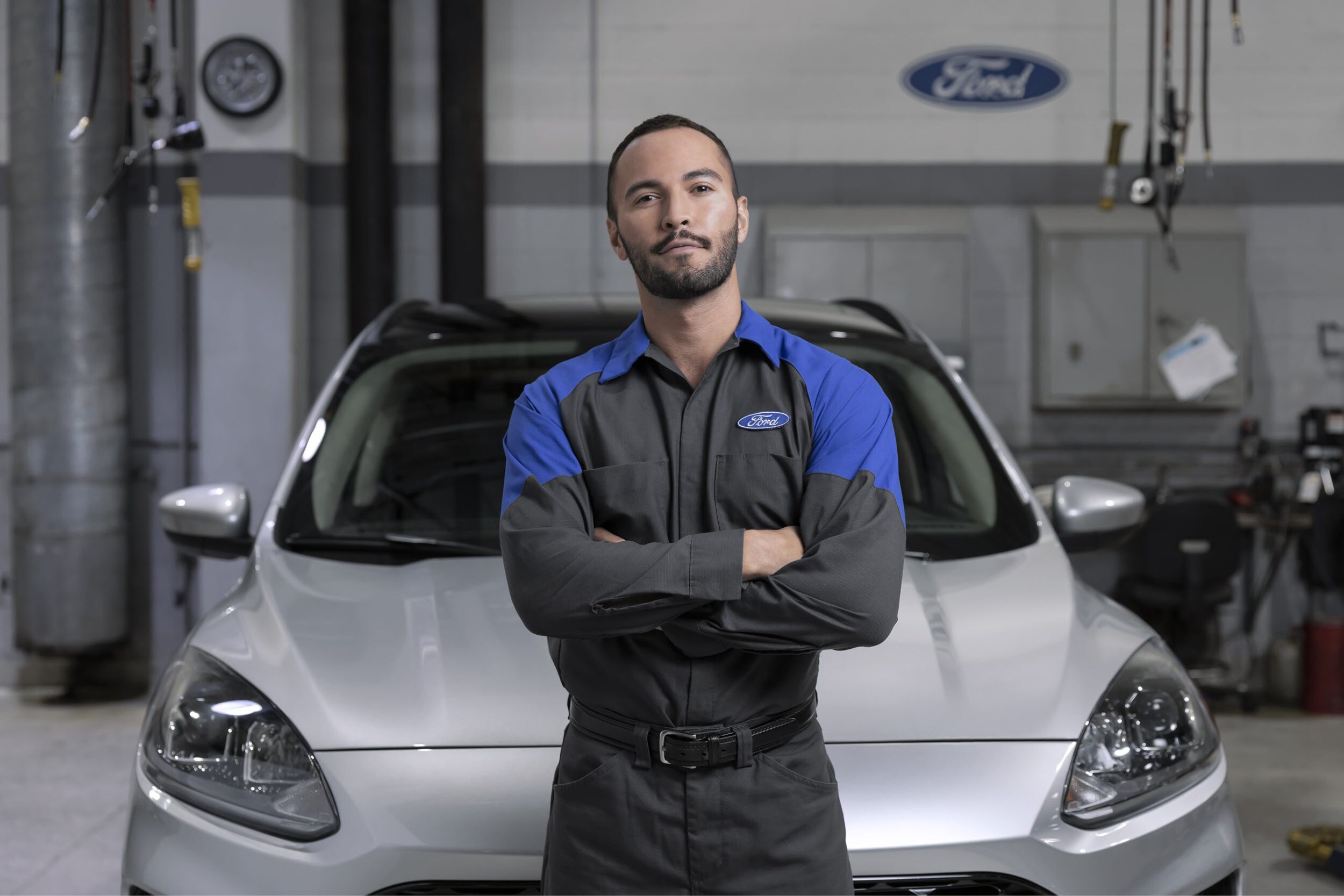 A Ford technician using advanced diagnostic equipment on a modern F-150 in the Bison Ford service bay.