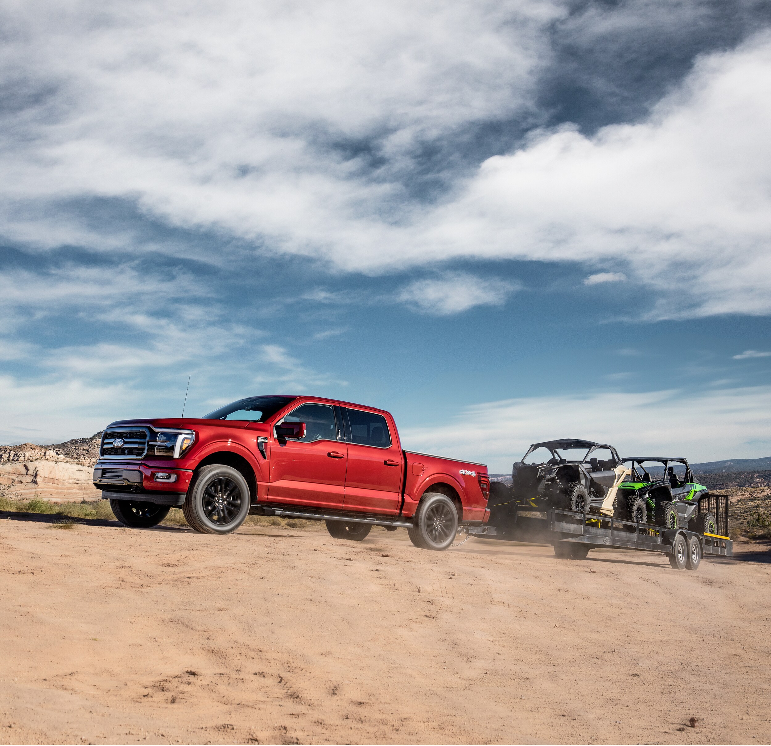 2025 Ford F-150 towing ATV on sand dunes