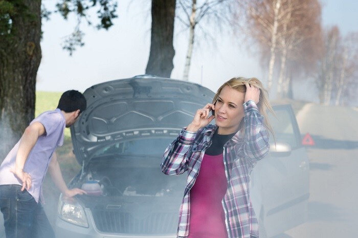 Couple dealing with an overheating engine