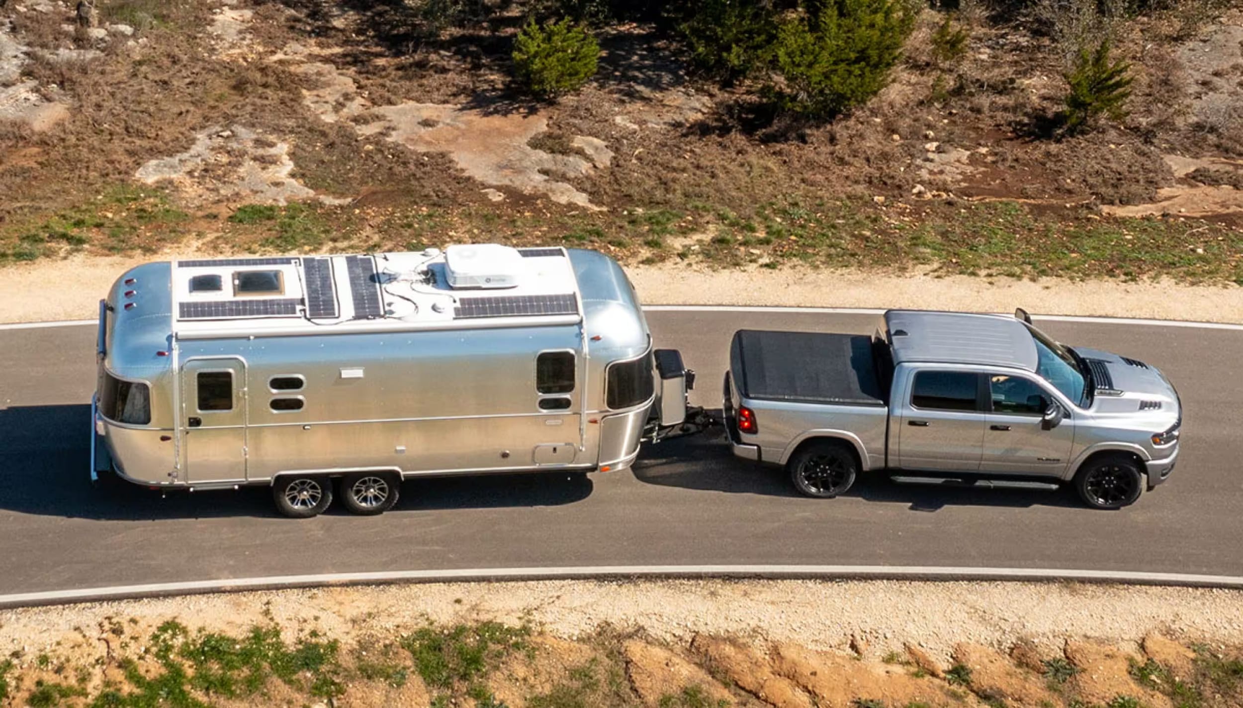 2025-ram-1500-towing-silver-camper.png