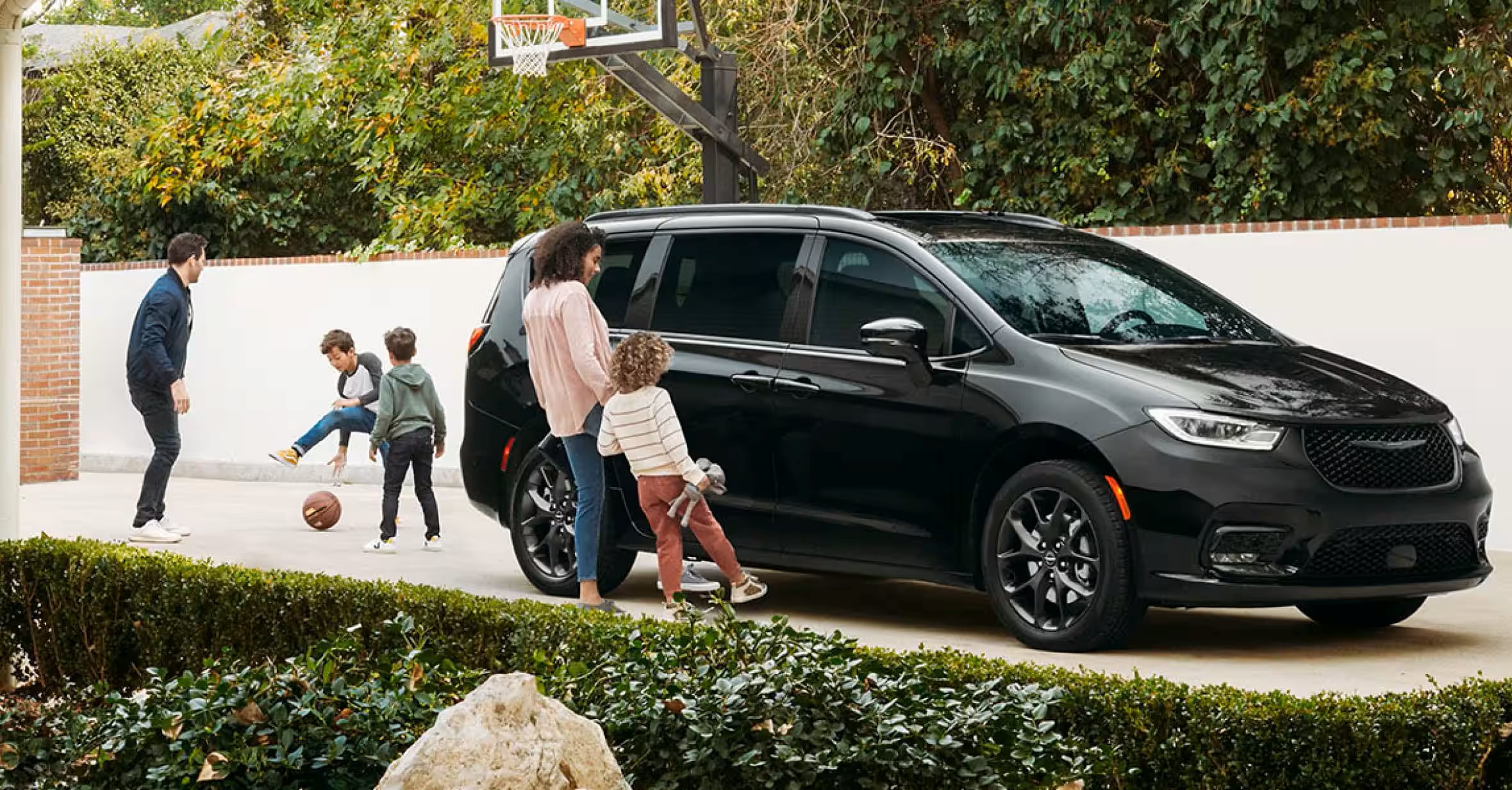 2026 Chrysler Pacifica in a driveway with a family