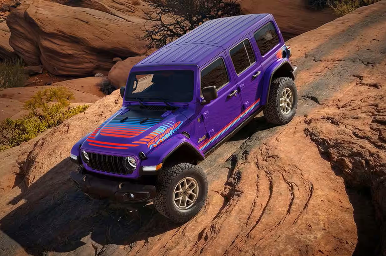 Purple Reign-colored Jeep Wrangler Rewind driving down rocky terrain