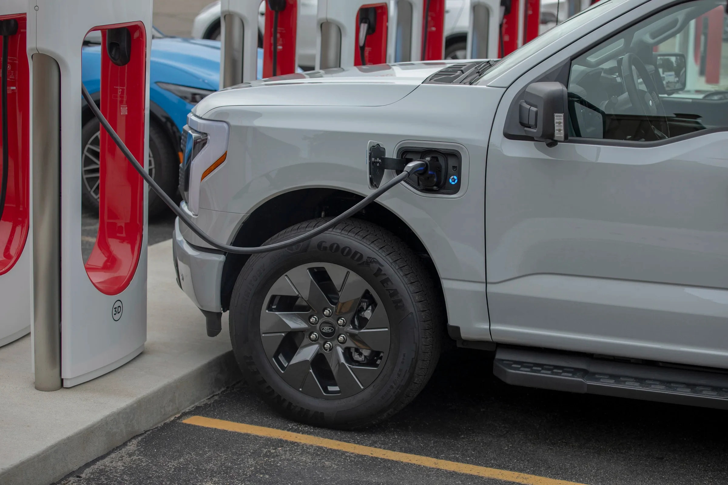 Ford electric truck charging at a Tesla charging station.
