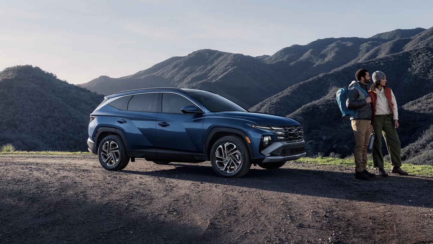 2026 Hyundai Tucson Hybrid on a mountain with a couple