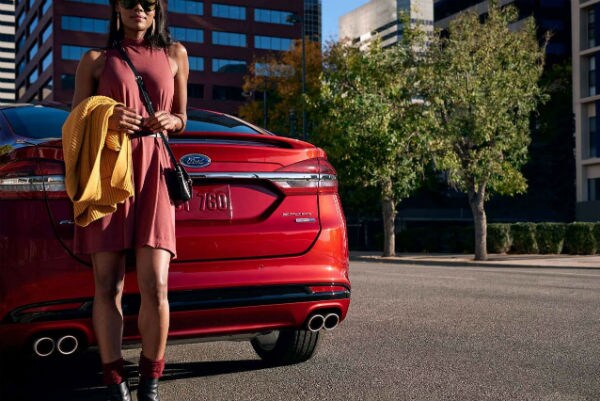 Ford Fusion lady standing against it Pottsboro, Tx Blake Utter Ford