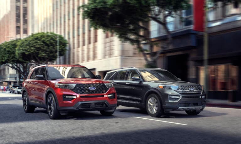 two new 2021 Ford Explorer SUVs driving 